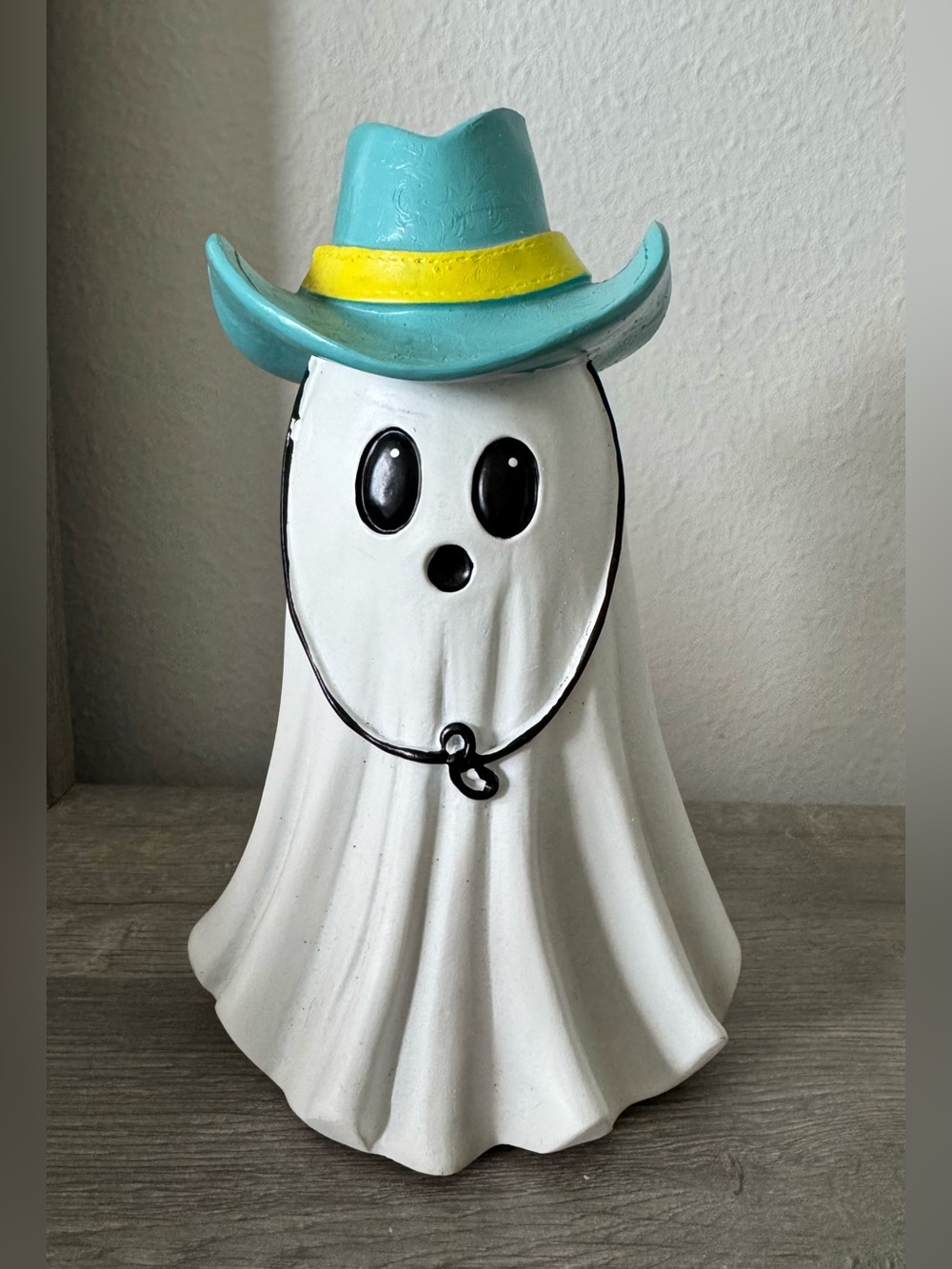 "Cowboy Ghost" for Halloween.
A white ghost with black eyes and mouth, adorned